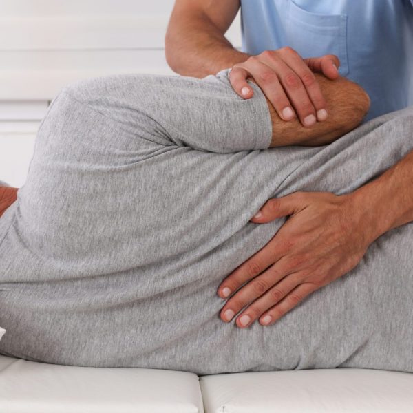 Chiropractic treatment, Back pain relief. Physiotherapy for senior male patient, Kinesiology